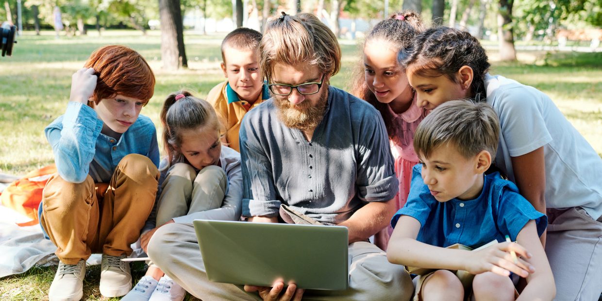 Showing pictures to kids at outdoor class